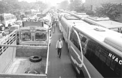 PRTC worker blocks the bus stand chowk after a clash in Patiala on Thursday. 