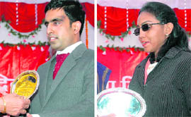 Anjali Arora and Pranab Lal receive the Excellence Award from Uttarakhand Governor Margaret Alva in Dehradun on World Disability Day on Thursday.