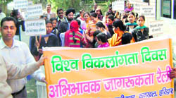 Social activists and students take out an awareness rally on World Disability Day in Haridwar.