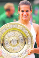 In this file photo Amelie Mauresmo holds her trophy at the Wimbledon Tennis Championships.