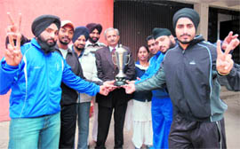 The winning team of MM Modi College, Patiala, with their trophy in Patiala on Friday.