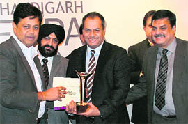 Sanjay Kumar, Finance Secretary, Chandigarh, honours traders during a function organised by the Chandigarh Beopar Mandal in Sector 17, Chandigarh, on Friday.
