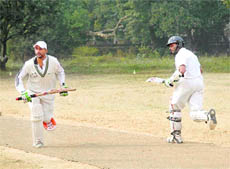 Batsmen cross over for a run during the Beehive T20 Cricket Tournament in Dehradun on Friday.