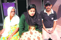 Anchal Sharma, widow of Rajneesh Sharma (centre), with her mother-in-law and brother-in-law at their residence in Jammu. 