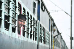 A passenger looks out of window after a train halted at Dhandari railway station.