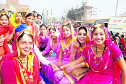 Girls in traditional clothes participate in a procession on the inaugural day of Virasat Mela in Bathinda on Friday. 