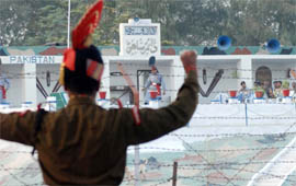 A BSF soldier shows angry gesture to the Pakistani Rangers across the fence during the Beating Retreat ceremony at Sadqi joint check-post near Fazilka on Saturday.
