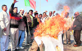 Members of the Uttarakhand BJP Minority Morcha burn effigies of Congress MPs from the state in Dehradun on Saturday