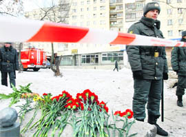 Police officers stand in front of the entrance to the Lame Horse nightclub in the Russian city of Perm where a fire took place on Friday midnight.