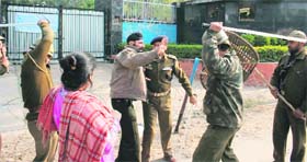 Policemen cane charge a protesting SPO outside the CRPF Group Centre at Bantalab in Jammu