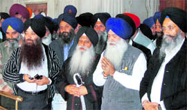 Prof Darshan Singh (third from right) pays obeisance at Akal Takht on Saturday.
