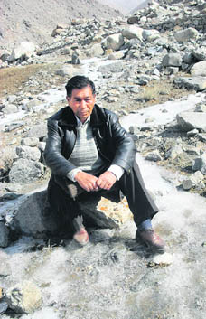 Chewang Norphel poses on the glacier forming outside Stakmo village