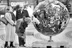 Visitors look at an art installation representing the planet in downtown Copehagen on Saturday