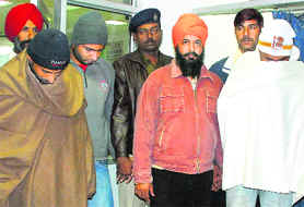 The accused involved in the murder of financier Harjinder Singh Dhillon being taken to hospital for medical examination in Chandigarh on Sunday.