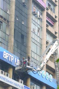 Firemen douse fire that broke out in the BPTP Ltd. office, DCM Buiding, Barakhamba Road, New Delhi