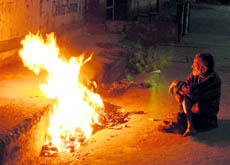 As mercury goes down, a homeless person burns garbage to keep himself warm in Dehradun on Sunday. Tribune photo: Anil P Rawat