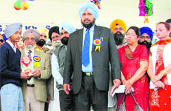 A student receives prize at GHG Khalsa Senior Secondary School in Mandi Ahmedgarh. 