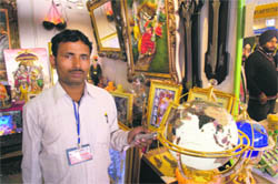 An employee at the international trade fair shows a China-made globe, which does not show J&K as part of India, in Amritsar on Sunday. 