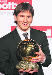 Barcelonas Lionel Messi holds the 2009 Ballon dOr trophy in Paris on Sunday. Messi was awarded the 2009 Ballon dOr by French magazine France Football.