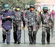 Nepalese police officers patrol a street in Kathmandu on Sunday