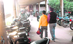 Two-wheelers parked inside a corridor near the subdivisional office building of the estate office at Sector 17 in Chandigarh. 
