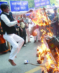 Demanding reservation in private sector enterprises, activists of the All-India Confederation of SCs/ STs burn effigies of leading businessmen at Jantar Mantar in New Delhi.