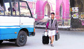 A passenger walks home in the absence of public transport.