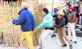 Cops capture a youth, who tried to move out of his house despite curfew in Ludhiana.