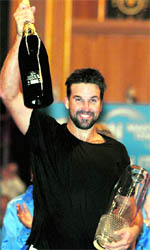 Australias Pat Rafter holds the winners trophy after defeating Swedens Stefan Edberg during their Champions Tour Masters final at the Royal Albert Hall in London on Sunday.  AP/PTI 