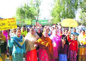 Irate women protest in front of the Civil Hospital, Nurpur, against the child specialists transfer