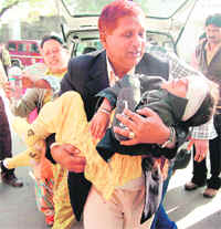 An injured girl being taken to the GMCH in Jammu on Tuesday. She was hurt when the Tata Sumo she was travelling in along with other members of the marriage party fell into a gorge. 