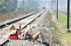 Cops from Phillaur lying on the railway tracks, waiting for orders to go back home. 