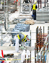Labourers work at a construction site in Tokyo