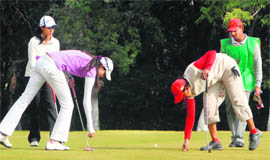 Saaniya Sharma does some repairs at the greens as Sharmila Nicollet (second from left) and Nalini Singh Siwach look on in Chandigarh on Wednesday.