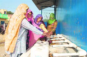 Women draw RO filter water at Silana village in Jhajjar district