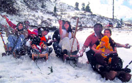Tourists ski at Nathatop in Jammu division on Thursday
