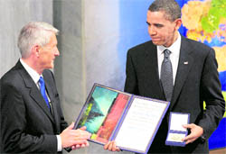 US President Barack Obama is applauded by Nobel Committee chairman Thorbjorn Jagland after he received the Nobel Peace Prize during a ceremony in the Main Hall of Oslo City Hall in Oslo on Thursday.