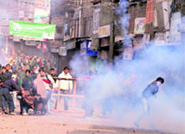 Protesters pelt stones at police personnel at Budshah Chowk in Srinagar on Friday. Tribune photos: Amin War 