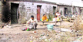 A migrant labourer, Ajay Singh, and his family share a room with another labourer at a vehra.