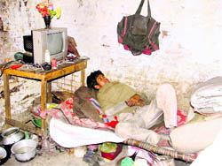 Another labourer, Uttam Kumar, in his room, which he shares with three other people, in Ludhiana.