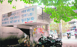 Advertisements deface a wall at a market in Sector 34, Chandigarh. 