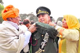proud parents of a gentleman cadet from Haryana pip stars on the shoulders of their son