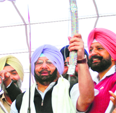 Captain Amarinder Singh holds a sword at a Congress rally held in Mohali on Saturday.