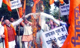 Rastrawadi Sena activists burn an effigy of Md Afzal Guru, who has been sentenced to death for his involvement in the 2001 Parliament attack, in New Delhi
