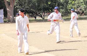 Batsmen crosses over for a run in the Beehive T20 Cricket Tournament in Dehradun