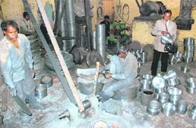 RK Saluja inspects works at his utensil manufacturing unit in Jagadhri