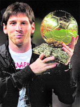 FC Barcelonas Lionel Messi holds up the new Ballon dor trophy before their Spanish La Liga match against Espanyol at the Camp Nou stadium in Barcelona on Saturday.