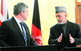 Afghan President Hamid Karzai (right) talks to British Prime Minister Gordon Brown during a joint press conference in Kandahar on Sunday. Brown is visiting troops in the volatile part of southern Afghanistan where thousands more coalition forces are to be deployed.