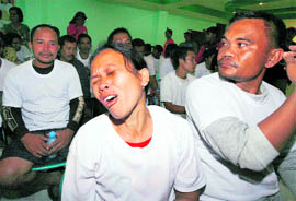 A woman, who was among the remaining hostages freed by armed tribesmen, cries after they were released and brought to a hospital in Prosperidad town in Agusan del Sur province, southern Philippines, on Sunday.