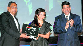 Bollywood actor Soha Ali Khan and Sun Direct TV COO Tony D'Silva launch India's first high definition services, as deputy managing director of Samsung R Zutshi (R) looks on, in New Delhi on Monday.